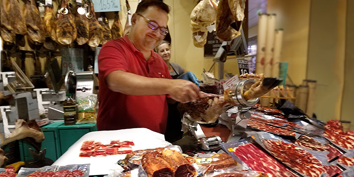 Carving ham at the La Encarnación Market Sevilla Spain