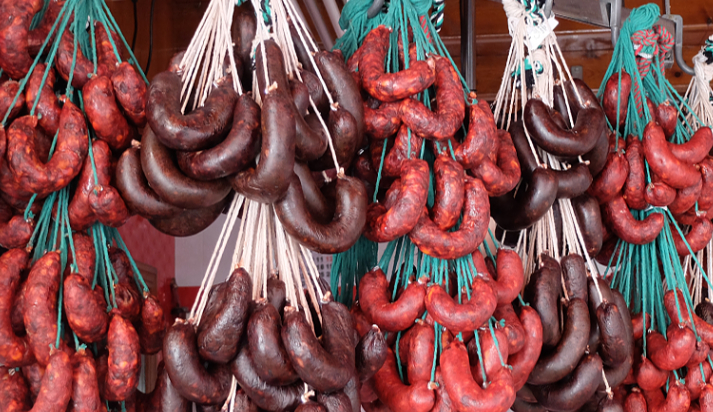 Sevilla Spain Feria Market Chorizo and blood sausages curing at a butcher shop at Mercado de Feria