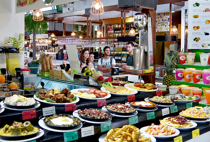 A huge selection of different dishes  at a food bar in the Mercado Victoria, Cordoba Spain